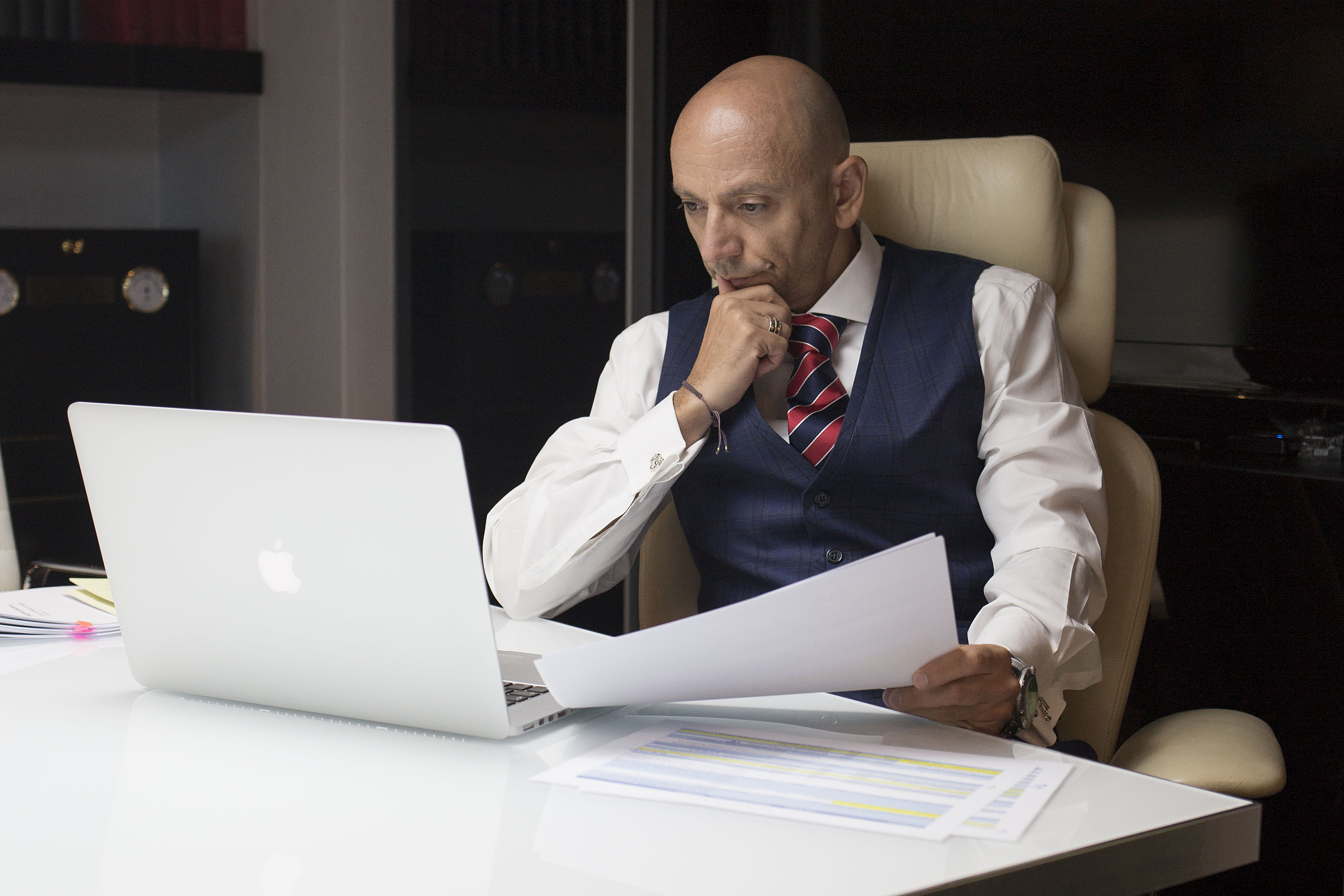 Christophoros Christophi reviewing documents in the firm's office